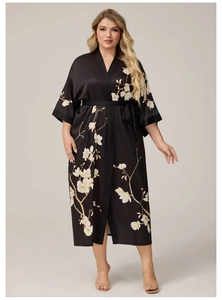 Détail du peignoir en satin noir avec imprimé floral blanc et ceinture nouée
