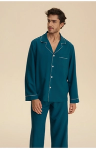 Detail of teal satin pajamas with contrasting white piping and refined V-neck buttoning