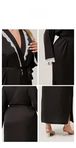 Detail view of black satin robe featuring white eyelash lace trim on collar and sleeves