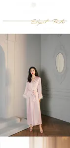 Pink silk robe with white feather trim cuffs and matching drawstring waist belt