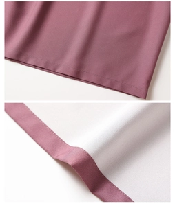 Detailed view of the flat-stitched hem and woven texture of the dusty pink robe garment