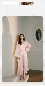 Three-piece satin pajama set with long robe, tank top, and pants featuring feather trim cuffs