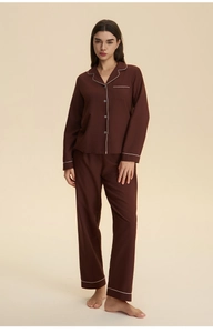 Detail of soft chocolate brown pajamas with elegant white piping and button-up lapels