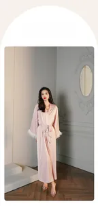 Luxurious pink satin robe with elegant white feather trim on sleeves in vintage setting