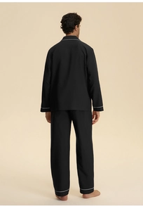 Rear view of men's black lounge pajama set with white piping on collar and cuffs