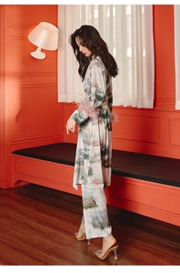 Detail of luxury satin pajama set with vintage landscape print and ostrich feather cuffs