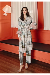 Detail of silk satin pajama robe with landscape print and pink feather trim on sleeves