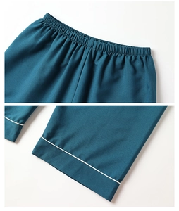 Detail of elastic waistband and white piping on navy blue cloud cotton pajama pants