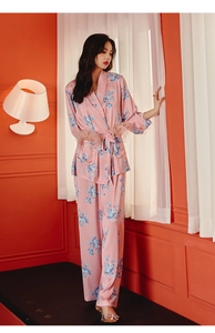 Detail of pink floral silk pajama set featuring feather trim and elegant satin finish
