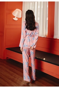 Pink floral satin pajama set featuring a long-sleeved top and pants with silky sheen