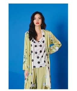 Detail of silk satin pajamas set with floral robe and polka dot camisole for women