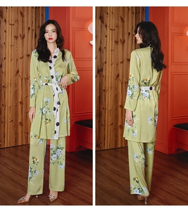 Detail of floral satin pajama set featuring polka dot piping and kimono tie closure