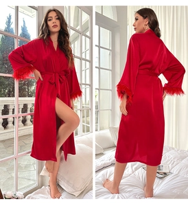 Luxurious red silk-style robe featuring elegant feather trim sleeves and belted waist detail