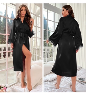 Detail view of black satin robe with elegant feather trim on sleeves and waist belt