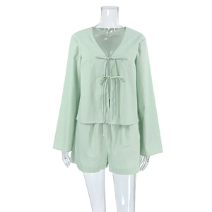 Detail of mint green long-sleeve lace-up top and matching shorts in soft cotton fabric