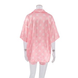 Rear view of pink satin pajama set featuring white gothic M letter diamond patterns