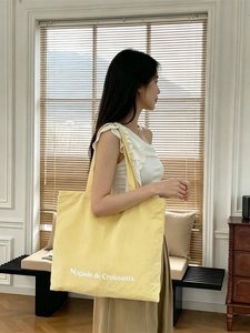 Minimalist large yellow canvas tote bag with lettering print for daily students use