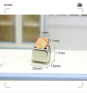 Detailed macro view of a 25x16x17mm miniature toaster model with two tiny bread slices