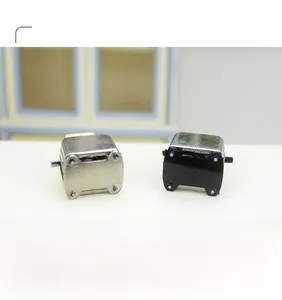 Detailed view of two 1:12 scale dollhouse miniature toasters with vintage design