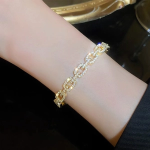Elegant gold plated chain bracelet with sparkling crystals on a female model wrist