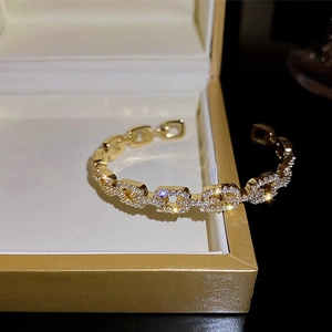 Elegant gold-plated chain cuff bracelet with shimmering cubic zirconia inlay details