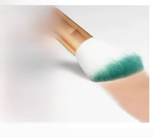 Macro shot of gradient soft makeup brush applying foundation smoothly for a seamless finish