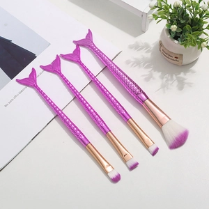 Detailed close-up of 4-piece mermaid makeup brush set with gradient scales and purple bristles