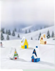 Set of four miniature European Christmas houses with snowy roofs for festive home decor