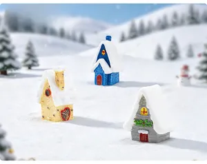 Close-up of resin mini Christmas houses in yellow blue and grey with snowy roof details
