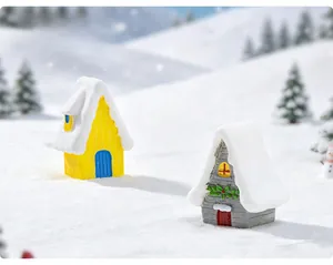Detailed macro view of resin Christmas village houses with faux snow on miniature roofs