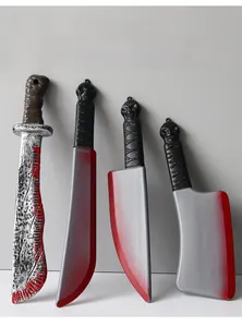 Detail of bloody Halloween prop knife set including machete and cleavers with skull handles