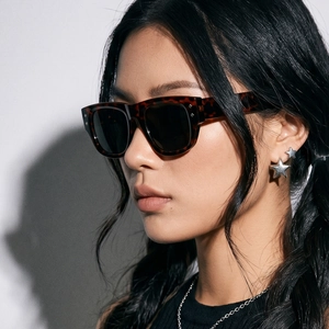 Classic tortoise shell square sunglasses with dark grey lenses on female model