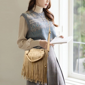 Beige crossbody bag with long tassels and adjustable strap in a bohemian style