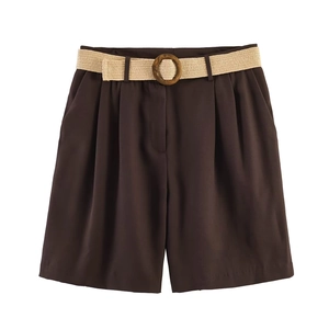 Detail of high-waisted coffee shorts with pleated waist and woven belt with buckle