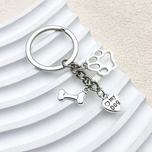 Silver pet keychain with bone, paw, and I love my dog heart pendant on white stone