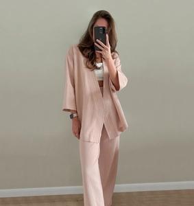 Close-up of premium textured cotton pajamas set featuring a long sleeve wrap top and wide pants