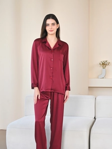 Detail of burgundy satin pajama set featuring a classic notched collar and chest pocket