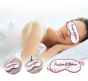 Close-up of pink striped silk sleep mask with Fashion & Pajama embroidery detail