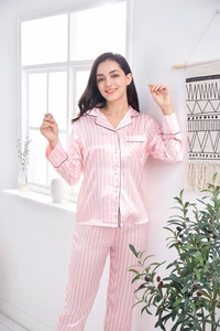 Detail of pink and white striped satin pajama set showing long sleeves and piping details