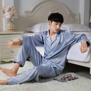 Detail of light blue satin pajama set featuring silk-like gloss and chest pocket detail