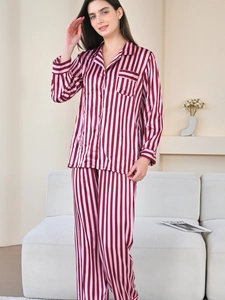 Detail of pink striped silk pajamas showing button-down lapel collar and soft texture