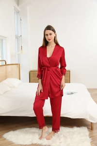 Detail of red silk pajama set with delicate lace trim on sleeves and trouser cuffs