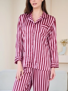 Cozy home setting showing pink striped silk pajamas set with long sleeve button-down shirt