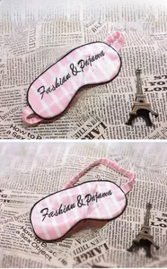 Detail of pink and white striped silk eye mask with Fashion & Pajama embroidery