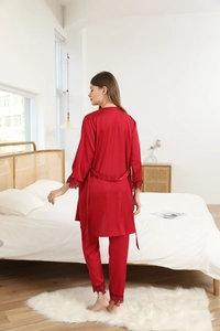 Detail view of red silk satin robe with elegant lace trim on sleeves and hem