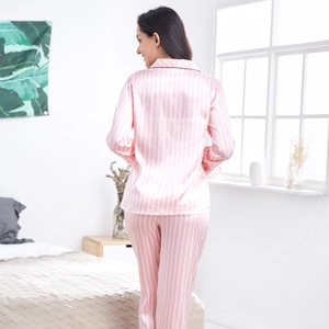 Women's pink striped satin pajama set featuring long sleeves and loose trousers