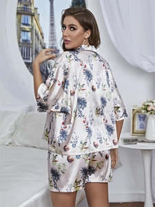Close-up of floral print satin pajamas with classic lapel and button-down details