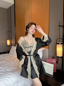 Detail of elegant black satin pajama set with intricate beige floral lace embroidery