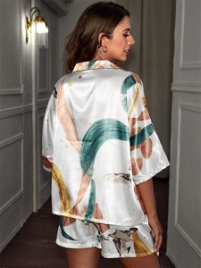 Detail view of ice silk pajama set featuring artistic print and satin texture finish