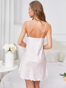 Close-up of pink satin nightgown with floral pattern and delicate back strap detail